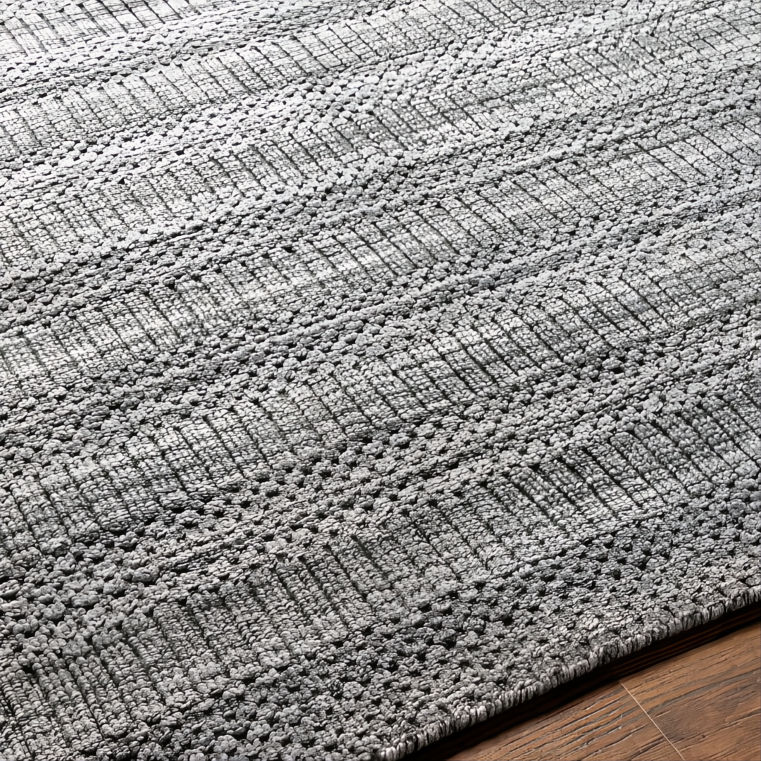 Surya Hickory HCK2303 area rug, hand-loomed from recycled PET yarn, featuring a textured gray, charcoal, and cream striped pattern.