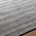 Surya Hickory HCK2303 area rug, hand-loomed from recycled PET yarn, featuring a textured gray, charcoal, and cream striped pattern.