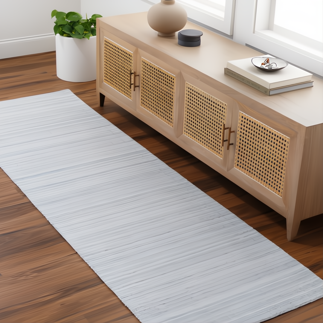 Light blue Surya Fresno runner rug, hand-loomed from recycled PET yarn, on a wood floor.