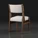 Surya Bergene dining chair with light beige upholstery and a brown natural rubber wood frame.