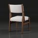 Surya Bergene dining chair with light beige upholstery and a brown natural rubber wood frame.