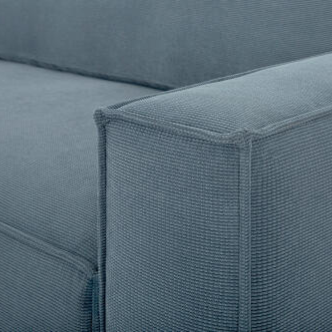 Close-up of a contemporary Surya Aira sofa with navy polyester upholstery and clean lines.