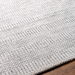 Surya Hickory HCK2302 hand-loomed rug in light beige, gray, and charcoal recycled PET yarn with textured stripes.