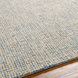 Surya Aiden hand-tufted wool area rug in light blue and cream, featuring a medium pile texture.