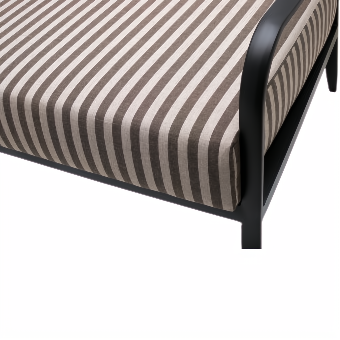 Surya Antibes outdoor sofa with brown and beige striped Sunbrella acrylic cushions and a black aluminum base.