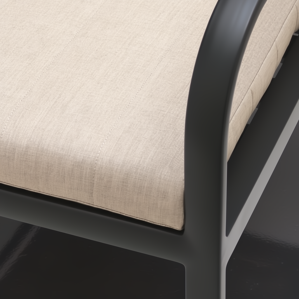 Close-up of a Surya Antibes dining chair with beige Sunbrella upholstery and a black aluminum frame.