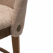 Surya Brooke counter stool with medium brown polyester upholstery, wheat-finished beechwood base, and decorative bronze accent.