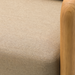 Close-up of Surya Palma outdoor sofa with beige Sunbrella upholstery and natural teak wood armrest.