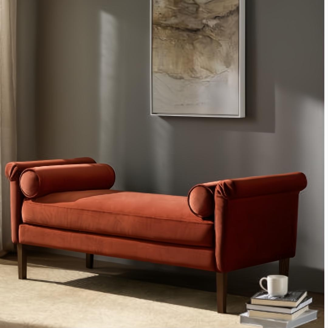 Surya Aneesa Bench with rust upholstery, brown rubber wood base, and bolster armrests.