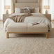 Light beige polyester Bradly Bench with a beige stained red oak base in a bedroom setting.