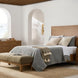 Brown natural Surya Hermosa nightstand with two drawers and metal pulls, next to a bed in a bright bedroom.