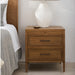 Surya Hermosa brown natural nightstand with two drawers, metal pulls, and a pull-out shelf.