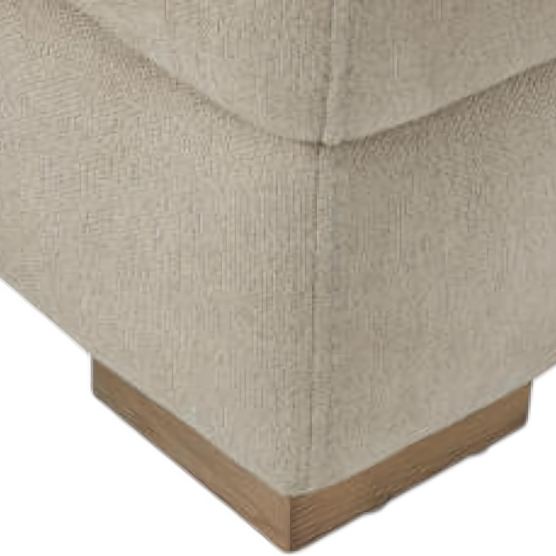 Close-up of a Surya Lloyd Power Sectional corner with light beige polyester upholstery and a brown stained plywood base.