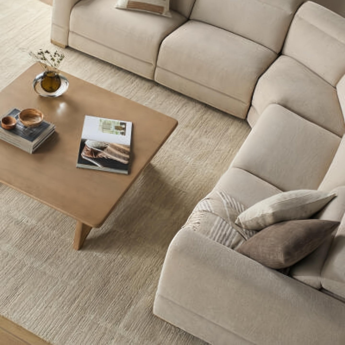 Beige polyester power reclining sectional with a light wood coffee table on a textured rug.
