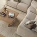Beige polyester power reclining sectional with a light wood coffee table on a textured rug.