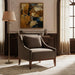 Brown recycled fabric accent chair with a rubber wood base in a living room setting.