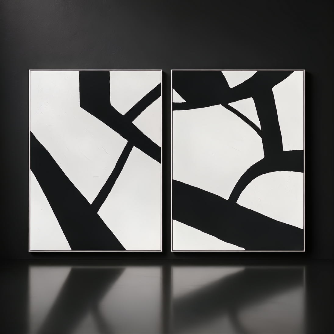 Two framed black and white abstract wall art pieces with bold lines, hand-painted on canvas.