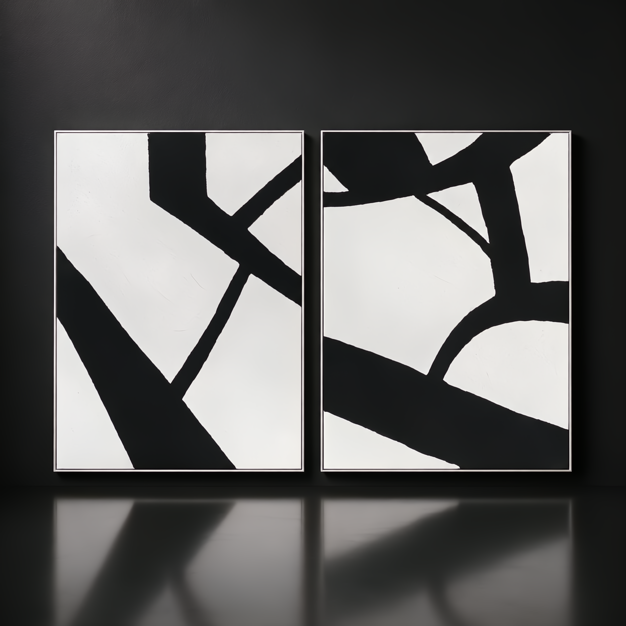 Two framed black and white abstract wall art pieces with bold lines, hand-painted on canvas.