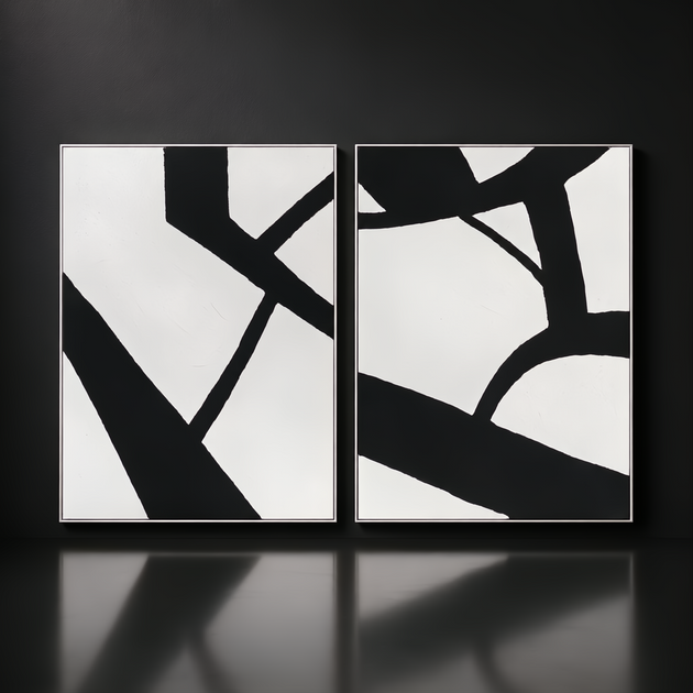 Two framed black and white abstract wall art pieces with bold lines, hand-painted on canvas.