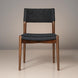 Surya Chia dining chair with brown stained ash wood frame and black woven seat and back.