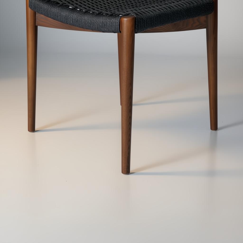 Surya Chia dining chair with brown stained ash wood base and black woven seat.