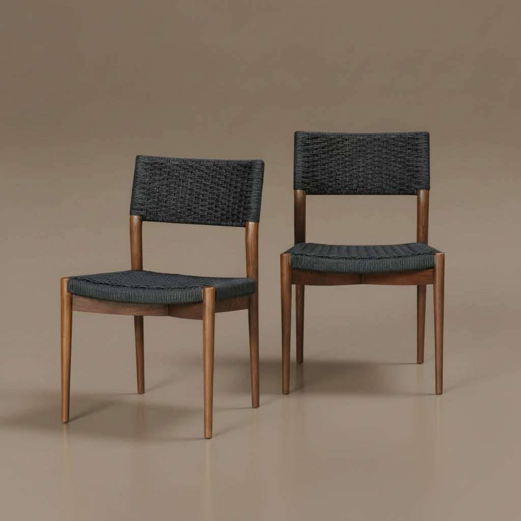 Two Surya Chia dining chairs with brown ash wood frames and black woven seats and backs.