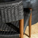 Close-up of a Surya Chia Dining Chair with dark woven rope seat and back, and brown ash wood legs.