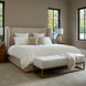 Surya Covina upholstered bed with a beige headboard, white bedding, and a matching tufted bench.