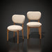 Set of two Surya Devin dining chairs with cream polyester upholstery and wheat-colored beechwood bases.