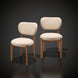 Set of two Surya Devin dining chairs with cream polyester upholstery and wheat-colored beechwood bases.