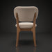 Surya Devin Dining Chair, cream polyester upholstery with wheat-colored beechwood base, back view.
