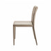Surya Eric dining chair with light brown PVC upholstery and khaki iron base, side view.