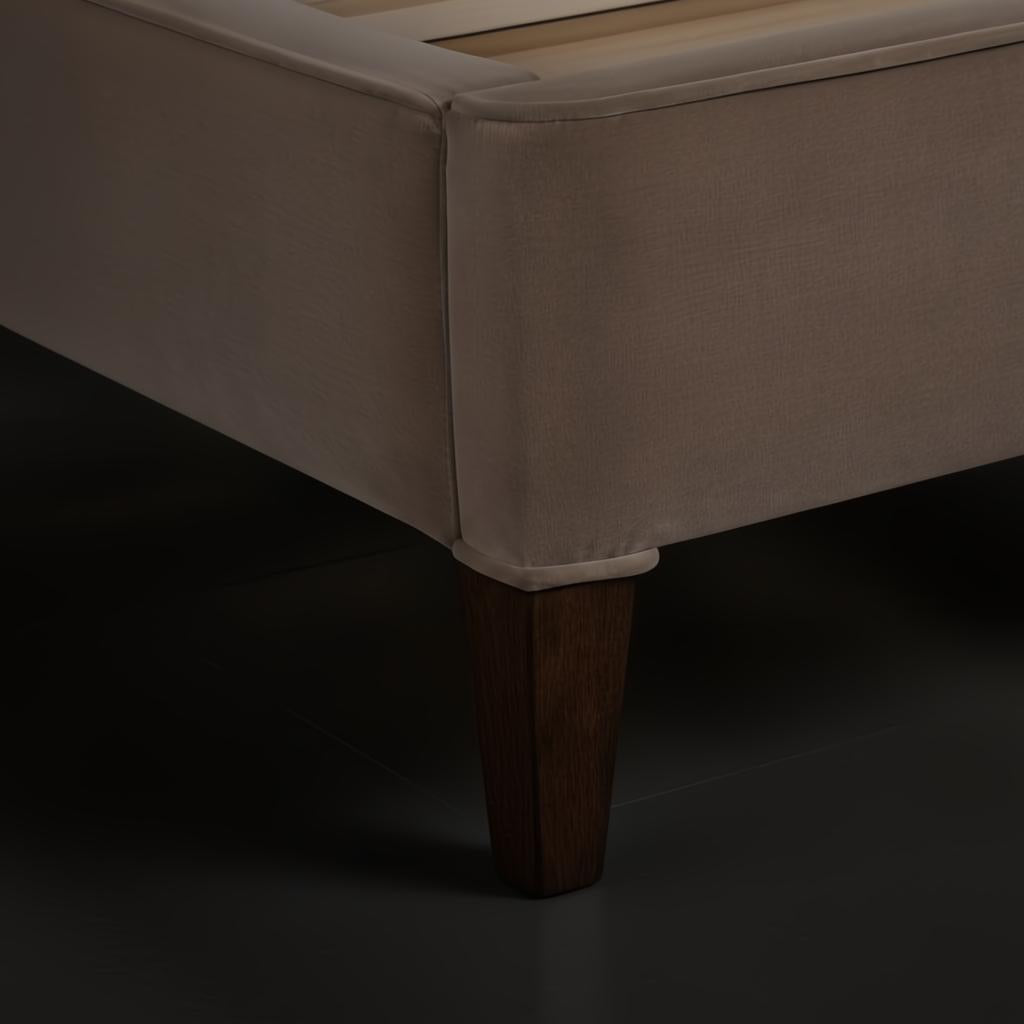 Surya Elipse upholstered bed with dark brown cotton and polyester fabric, and a dark brown stained wood leg.