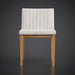 Surya Joanne dining chair with off-white polyester upholstery, vertical channel tufting, and a wheat rubber wood base.