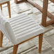 Surya Joanne dining chair with off-white ribbed polyester upholstery and wheat rubber wood base.