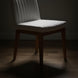 Surya Joanne dining chair with off-white polyester upholstery and wheat rubber wood base on a wooden floor.