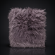 Surya Kharaa Throw, a plush, shaggy purple-grey faux fur blanket with a soft, woven texture.