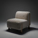 Off-white polyester accent chair with a soft, textured look and light brown rubber wood legs.