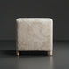 Off-white polyester accent chair with a soft, shaggy texture and light brown rubber wood legs.