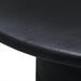 Close-up of a black brushed mango wood dining table with visible wood grain and a turned base.