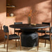 Surya Koben 60" round black brushed mango wood dining table with a turned base and four chairs.