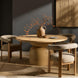 Modern beige mango wood round dining table with a thick pedestal base.