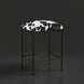 Surya Kornel counter stool with a black iron frame and a black and white cowhide-patterned seat.