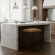 Surya Kornel counter stool with a brown polyester seat and black powder-coated iron base in a kitchen.
