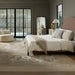 Surya Elipse Upholstered Bed with a curved headboard, dark brown base, and light bedding in a modern bedroom.