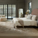 Surya Elipse Upholstered Bed with a curved headboard, dark brown base, and light bedding in a modern bedroom.