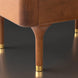 Close-up of a Surya Madri wood bed leg, featuring brown stained poplar with a minimalist modern design and brass cap.