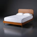 Surya Madri brown stained poplar wood bed with minimalist modern design and slatted headboard.