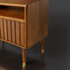 Brown Madri nightstand with a minimalist modern design, poplar top, fluted drawer, and brass-capped legs.