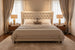 Brown Madri nightstand with poplar top and minimalist modern design, flanking a bed.